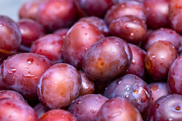 Ripe washed plums close up. Abstract background.
