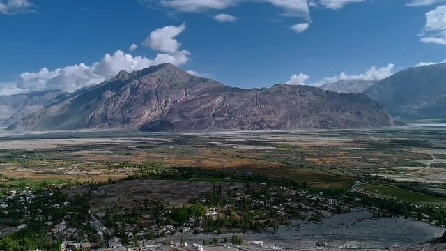 bird eye aerial view of a beautiful small himalayan village settlement in a fertile valley. bright summer day light. nubra valley, ladakh, india