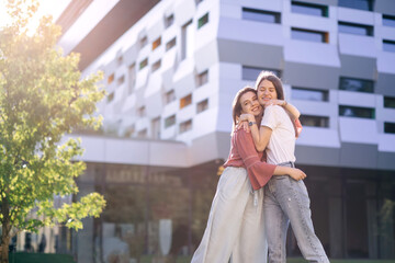 two girls hugging near the college,glad to see each other after the holidays