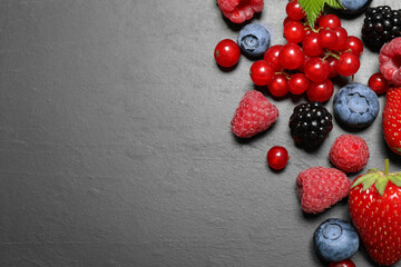 Different fresh berries on grey background, flat lay. Space for text