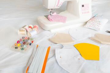 Creating washable face mask with sewing machine. Making DIY face mask during coronavirus pandemic crisis. Concept of shortage of medical mask, handmade mask. Selective focus