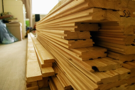 Construction boards lying on the floor in an apartment where renovations are in progress, bllured background