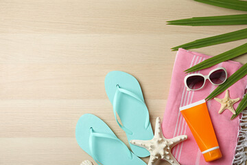 Flat lay composition with beach objects on wooden background. Space for text