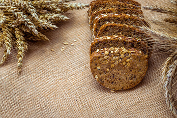 Sliced Multigrain. Rye bakery with crusty loaves and crumbs. Fresh loaf of rustic traditional bread...