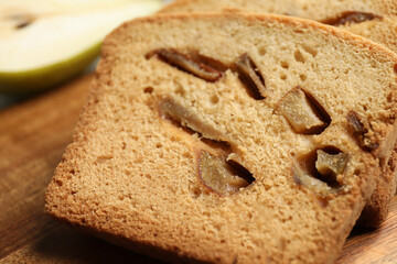 Slices of tasty pear bread on wooden board, closeup. Homemade cake