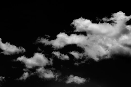 Isolated clouds over black.