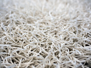 A fragment of a carpet with a long rope pile