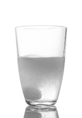 Tablet in a glass of water on a white background