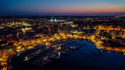 Fototapeta na wymiar Aerial view of the port of Bisceglie at night - Historic marina in the south of Italy, in the region of Apulia, near the Adriatic Sea