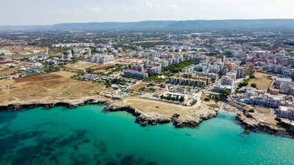 Fototapeta premium Aerial view of Monopoli in Apulia, south of Italy - Irregular coast with sandstone cliffs and blue waters along the Adriatic Sea