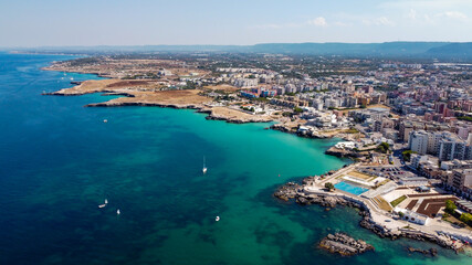 Fototapeta na wymiar Aerial view of Monopoli in Apulia, south of Italy - Irregular coast with sandstone cliffs and blue waters along the Adriatic Sea
