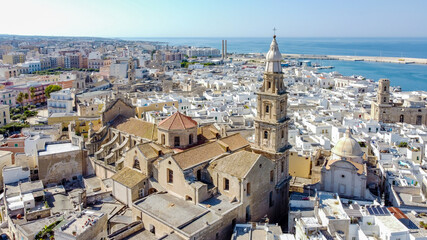 Aerial view of Monopoli in Apulia, south of Italy - Monopoli Cathedral aka Basilica of the Madonna della Madia from above, in front of the Adriatic Sea - Side view