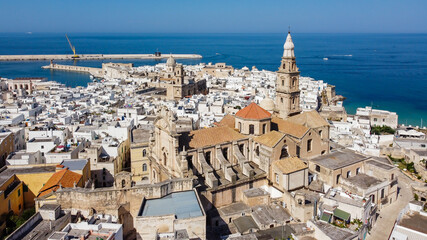 Obraz premium Aerial view of Monopoli in Apulia, south of Italy - Monopoli Cathedral aka Basilica of the Madonna della Madia from above, in front of the Adriatic Sea - Side view