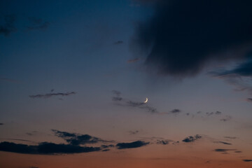 night summer sky background with sunset sky and young moon