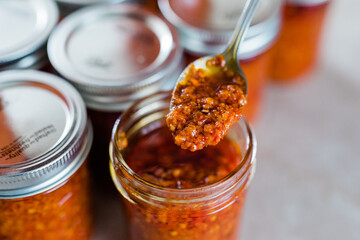 A spoon with Thai Chili Paste / Chili Sauce (also called chili oil, or Naam Prik Phao)