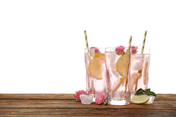 Delicious refreshing drink with rose flowers and lemon slices on wooden table against white background. Space for text