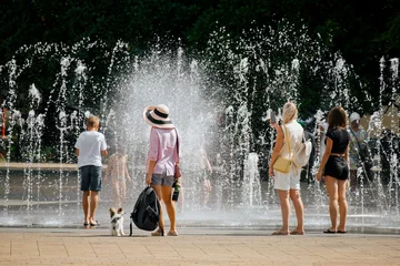 Sochi,Russia, 22 August 2020 - people refresh themselves at the city fountain in the summer heat © dvulikaia