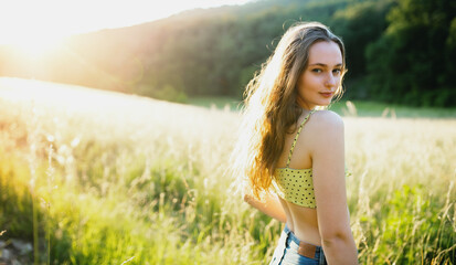 Portrait of young teenager girl outdoors in nature at sunset.