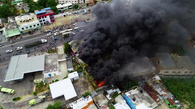 Aerial view around a raging building fire, smoke rising due to a accident, in Rio de Janeiro, Brazil - orbit, drone shot