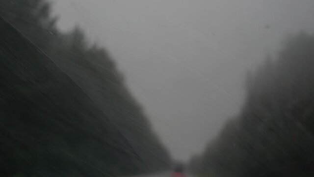 raindrops colliding with car windshield