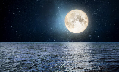 Full moon over the sea at night starry sky. Moonlight landscape.
