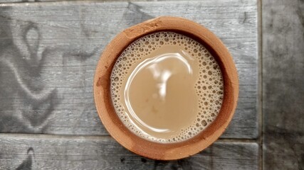 A kulhar or kulhad cup (traditional handle-less clay cup) from North India filled with hot Indian tea