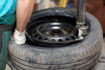 Mechanic changing car tire fitting. Wheel tyre repairing.