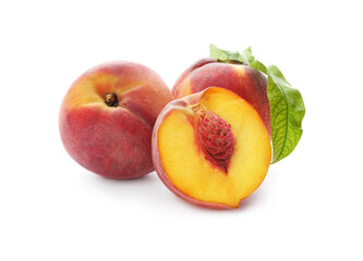 Whole and cut ripe peaches with leaves isolated on white