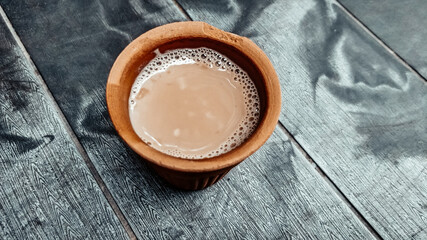 A kulhar or kulhad cup (traditional handle-less clay cup) from North India filled with hot Indian...