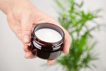 Pure shea butter in jar. Skin and hair care product, natural cosmetics. Anti-aging treatment.