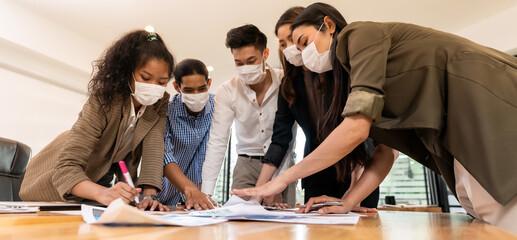 Panorama Interracial business team wear face mask brainstorm at new normal office