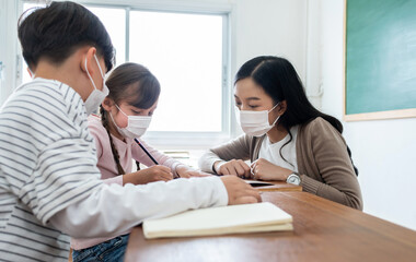 Diversity Children and teacher with protective face mask at school while virus pandemic