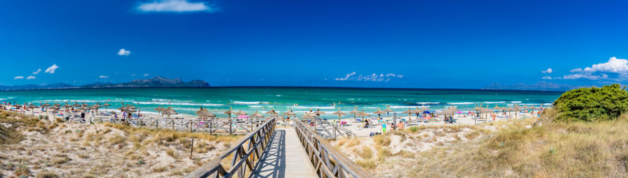 PLAYA DE MURO, Mallorca, Spain - 23 July 2020 - People enjoying hot summer day on popular city beach in Mallorca.