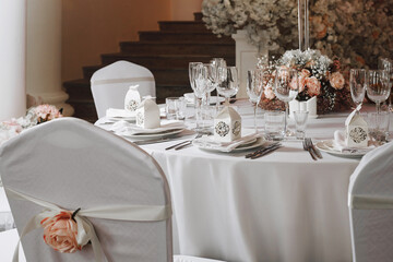 tableware Glasses, flower fork, knife served for dinner in restaurant with cozy interior