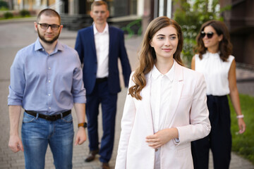 Different people walking on modern city street