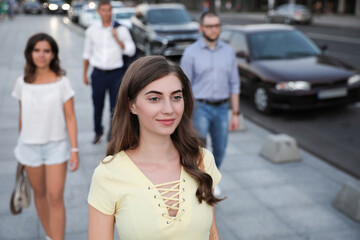 Young beautiful woman walking on modern city street