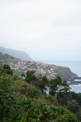 The view of the cliffs and Seixal village in Madeira Island, overcast day.