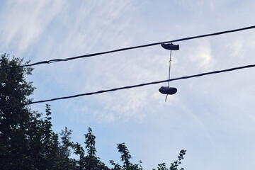 Shoes hanging on electric wires on the street