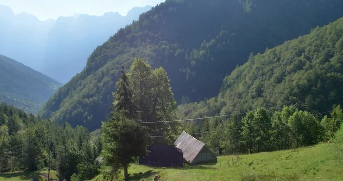 view of the mountains with smal hut in a valley