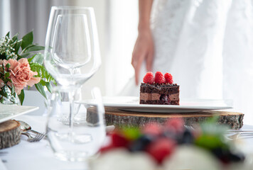 wedding table setting with wedding dress in the background