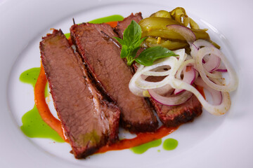 Beef Brisket Classic Texas Smoked BBQ Traditional Texas Smoke House Beef Brisket barbecue. Rubbed with spiced and slow smoked in a classic Texas smoke house over mesquite wood chips in smokehouse.