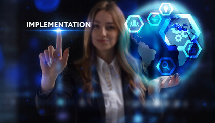 Business, Technology, Internet and network concept. Young businessman working on a virtual screen of the future and sees the inscription: Implementation
