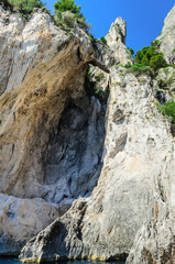 Capri Island View from the sea of the grotto, cliffs and arch-shaped rock formation (Arco Naturale) from the Paleolithic age overlooking the sea