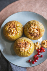 vegan dessert of baked apples with walnuts and red currant
