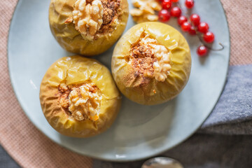 vegan dessert of baked apples with walnuts and red currant
