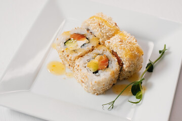 Rainbow sushi roll, uramaki, hosomaki and nigiri. Japanese oriental cuisine. Sushi rolls with avocado.