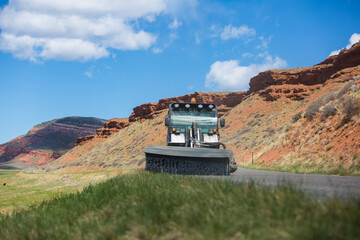 Street sweeper cleaning road in desert landscape, Wyoming, USA