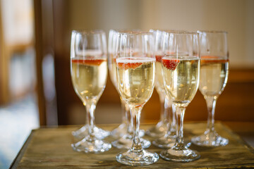 banquet glasses filled with champagne on a wooden table, celebration