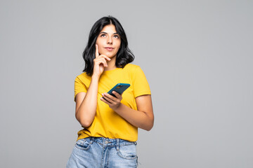 Portrait of young girl using cell free time smm blog post copy space isolated on gray background