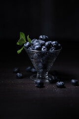 Fototapeta na wymiar blueberries in dark mood space